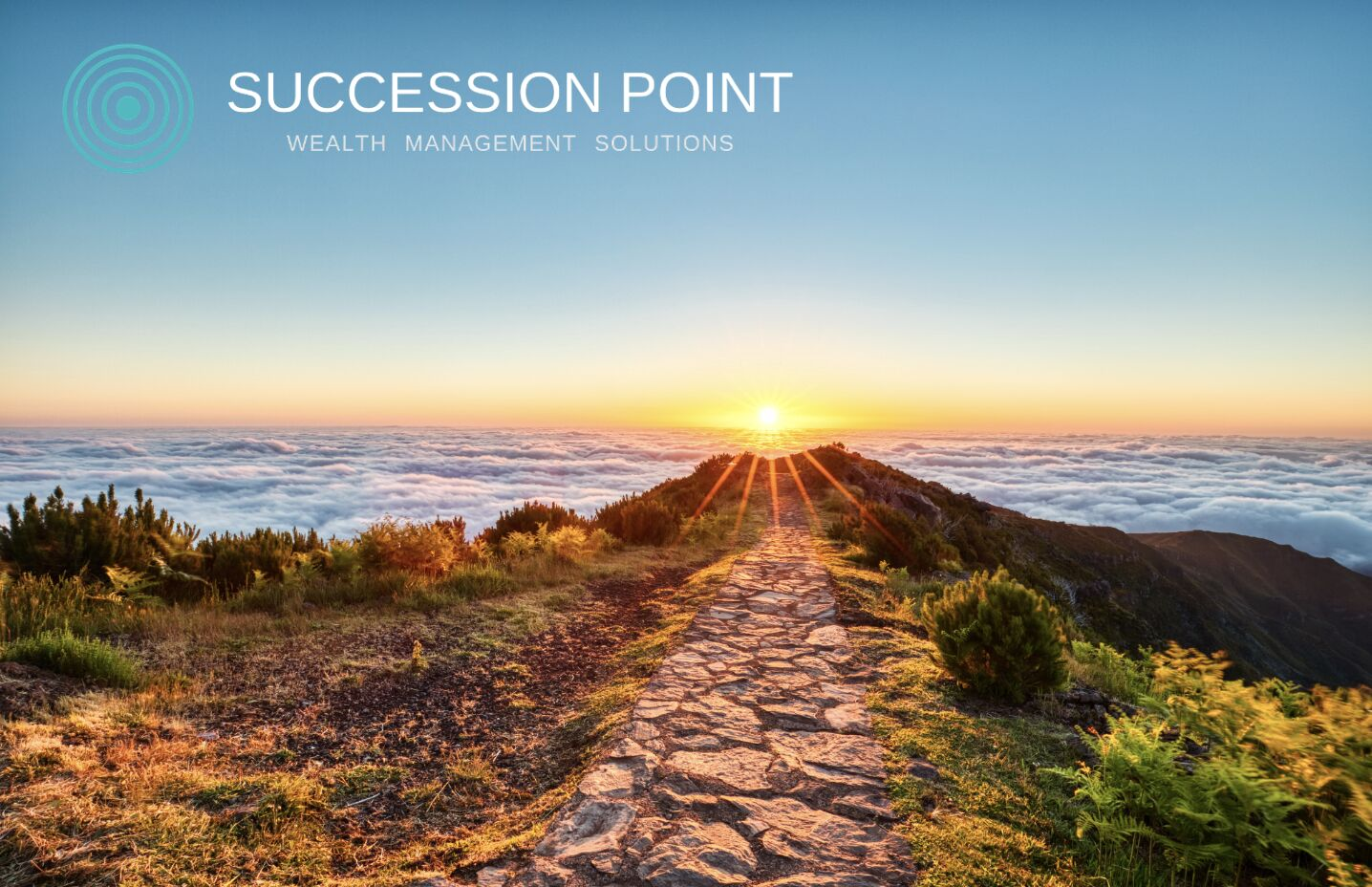 A stone path leading toward a sunrise above the clouds